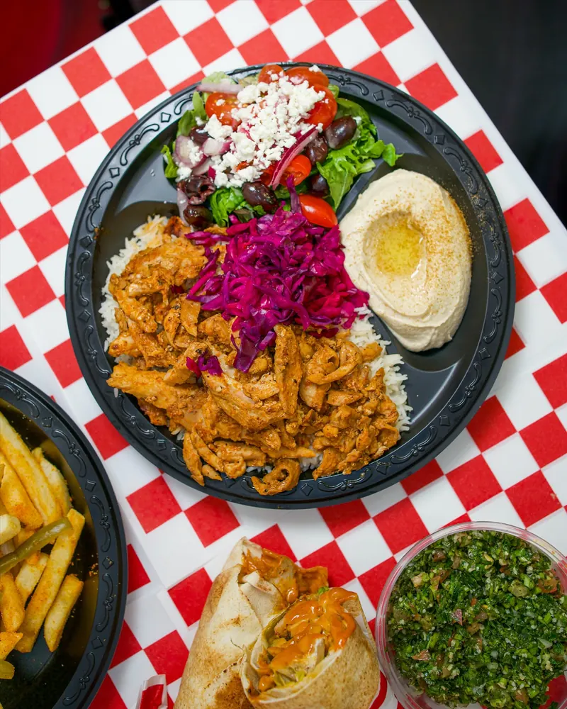 Chicken shawarma plate with feta salad, hummus and pickled cabbage