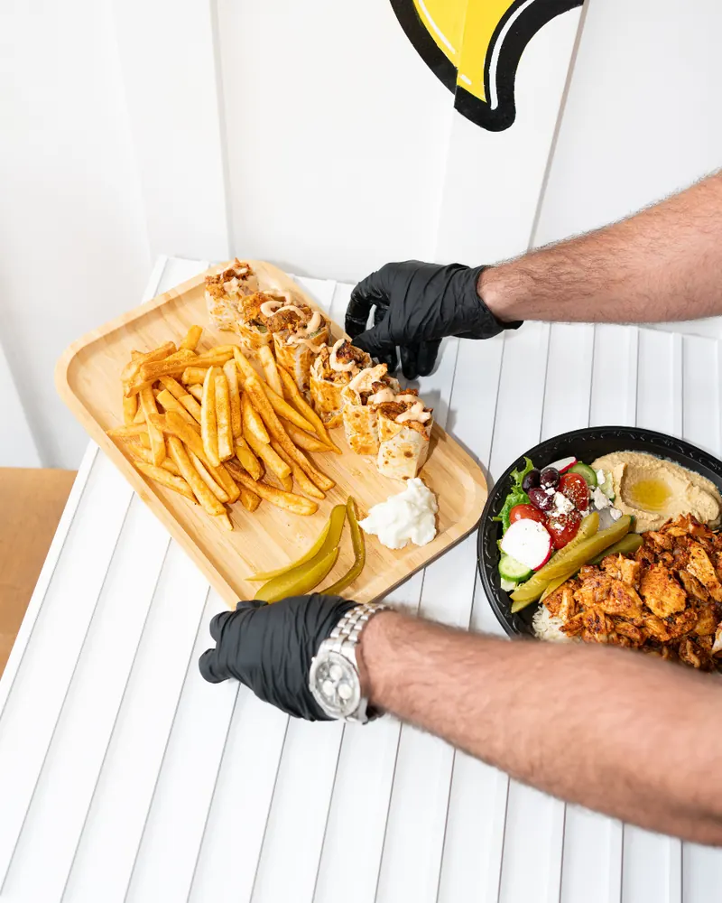 Plating shawarma bites and fries at the counter