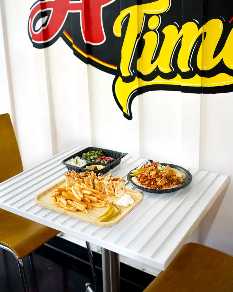 Fries, shawarma bites and a plate on a dining table