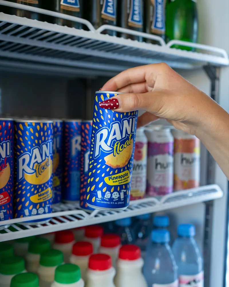 Cans of Rani juice in the drinks fridge