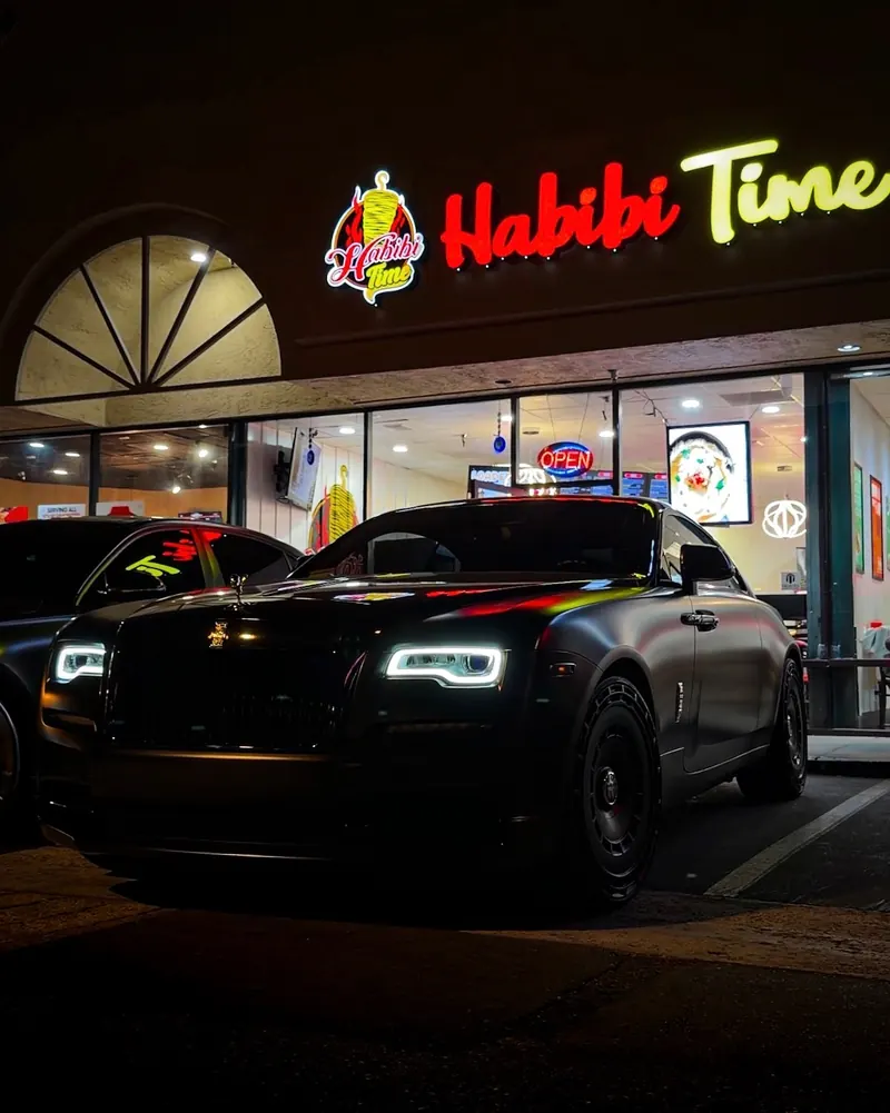 The Habibi Time storefront lit up at night