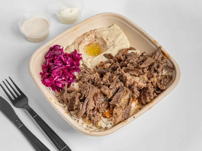 Beef shawarma grain bowl with hummus and pickled cabbage over rice