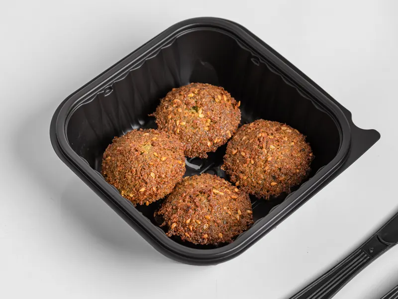 Four falafel in a to-go box
