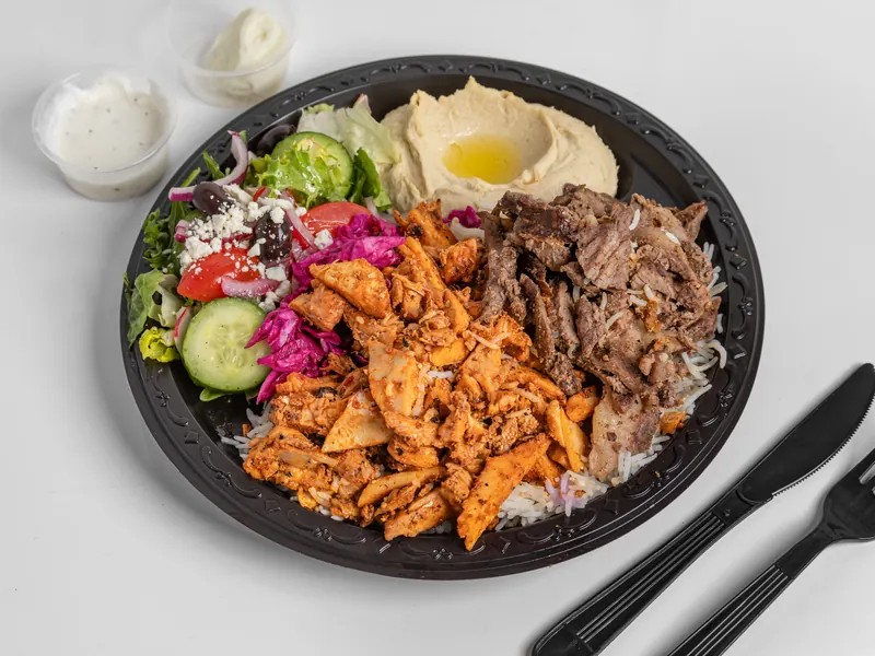 Mixed chicken and beef shawarma plate with basmati rice, hummus and Mediterranean salad